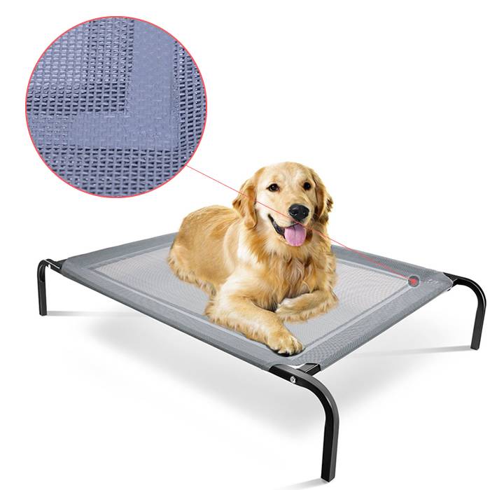 A golden retriever is lying on the textilinene surface raised pet bed.